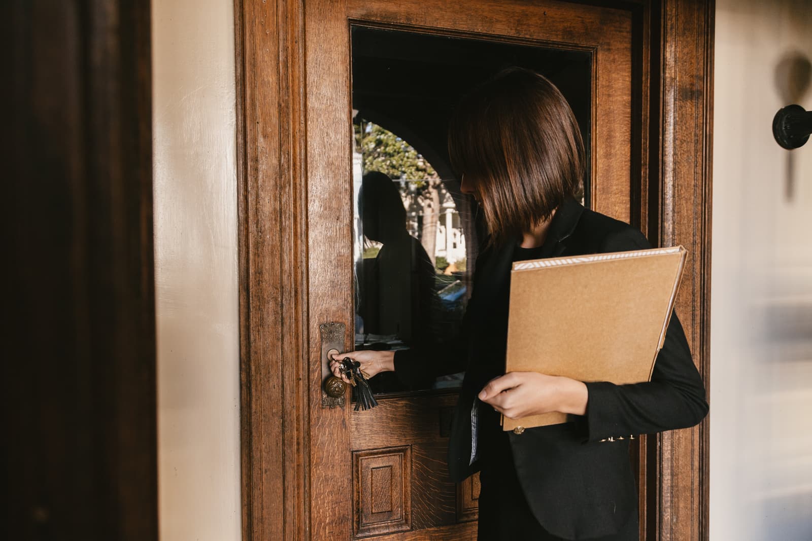 A woman unlocking the door of a new business premises